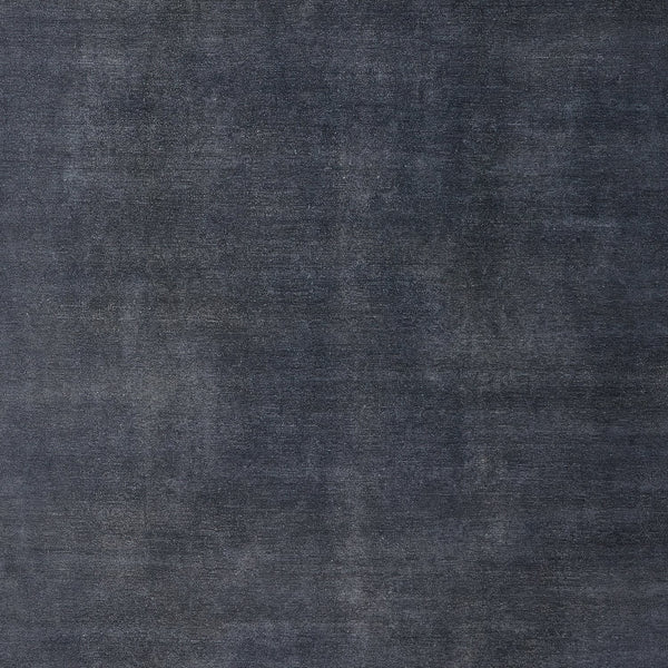 Close-up of a weathered, denim-like textured surface in dark blue and gray shades.