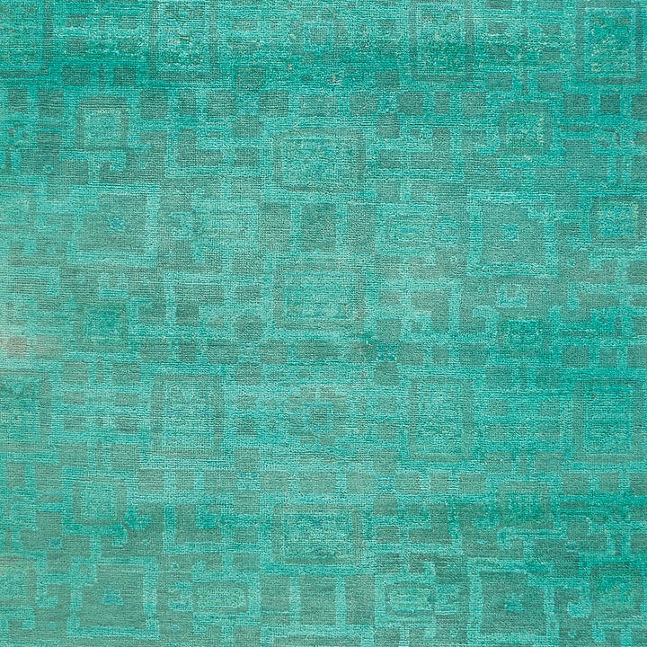 Textured surface showcasing a vintage, grid-like pattern in green shades.