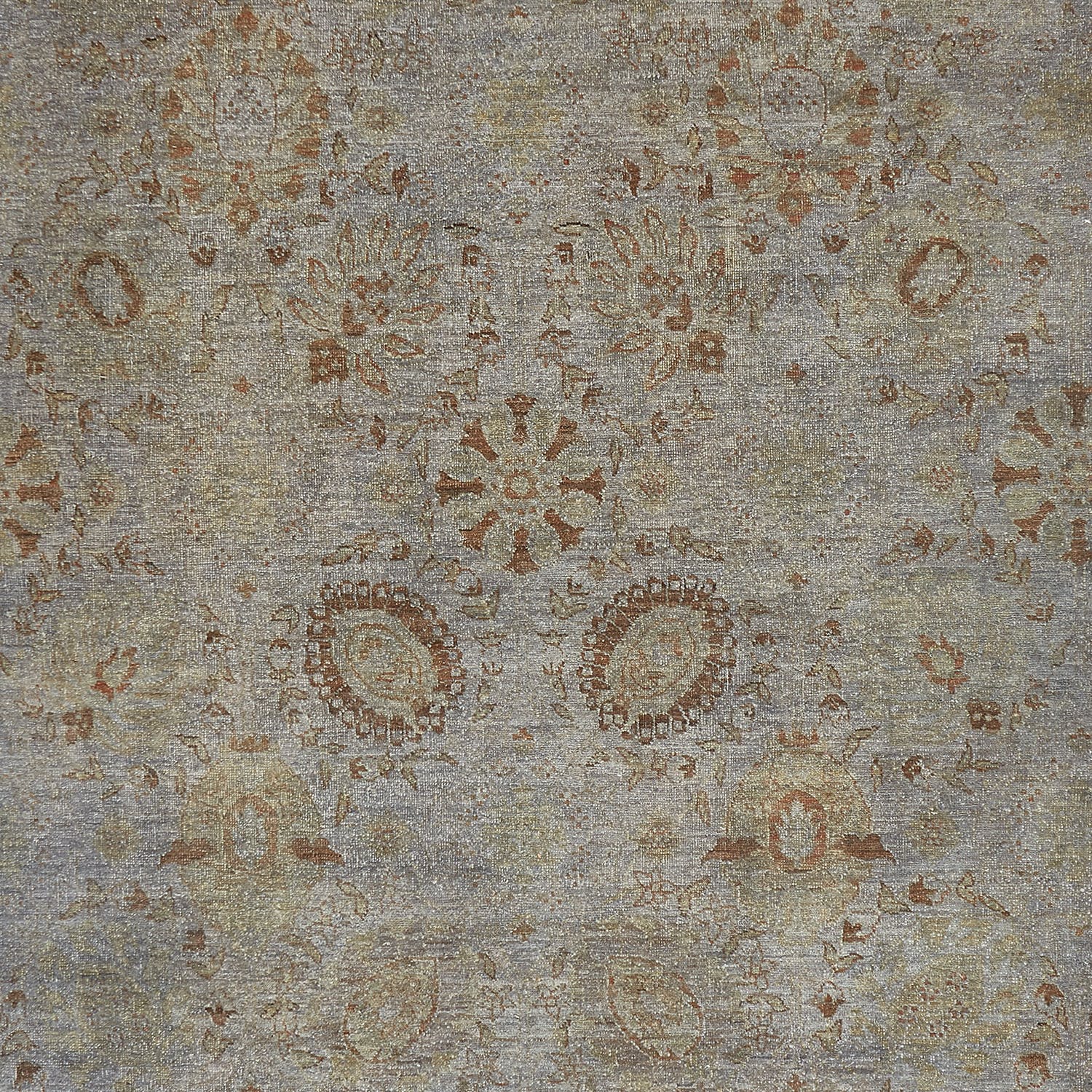 Patterned fabric with decorative motifs in warm earth tones on gray background.