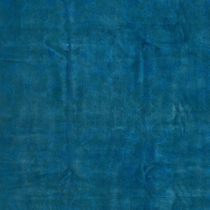 Close-up of a deep blue, textured surface with organic motif