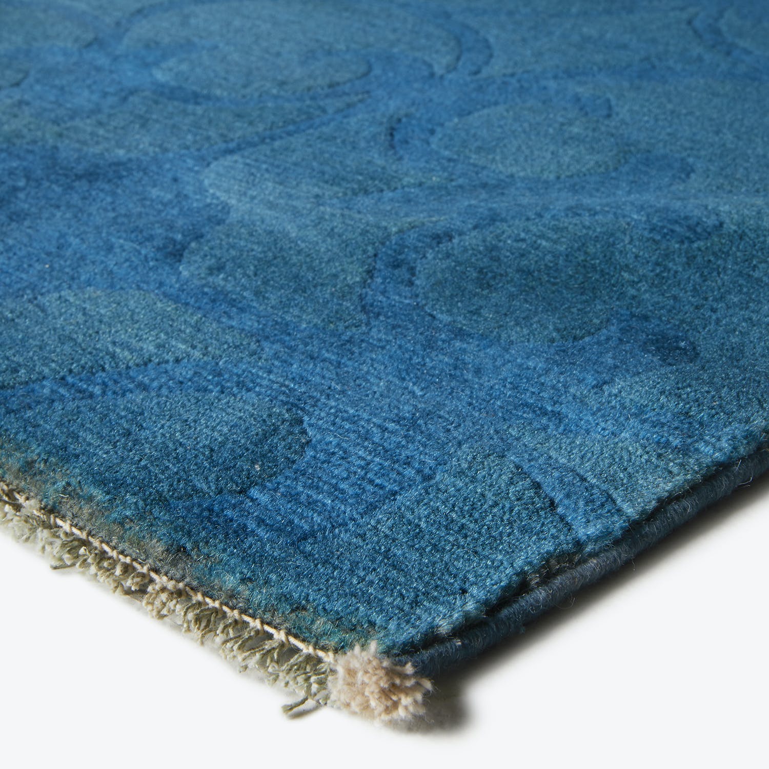Vibrant blue plush rug with textured pattern, handmade and luxurious.