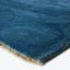 Close-up of a deep blue rug with soft, dense texture.