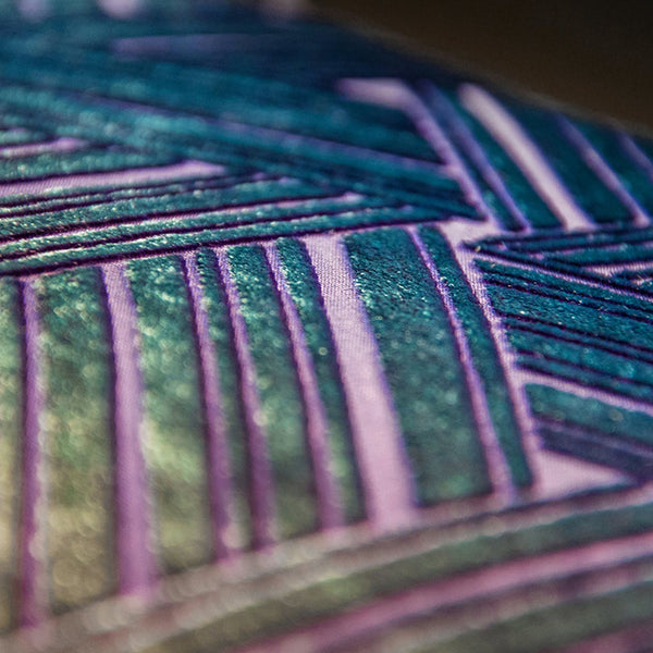 Close-up of a vibrant, geometric fabric with metallic accents.