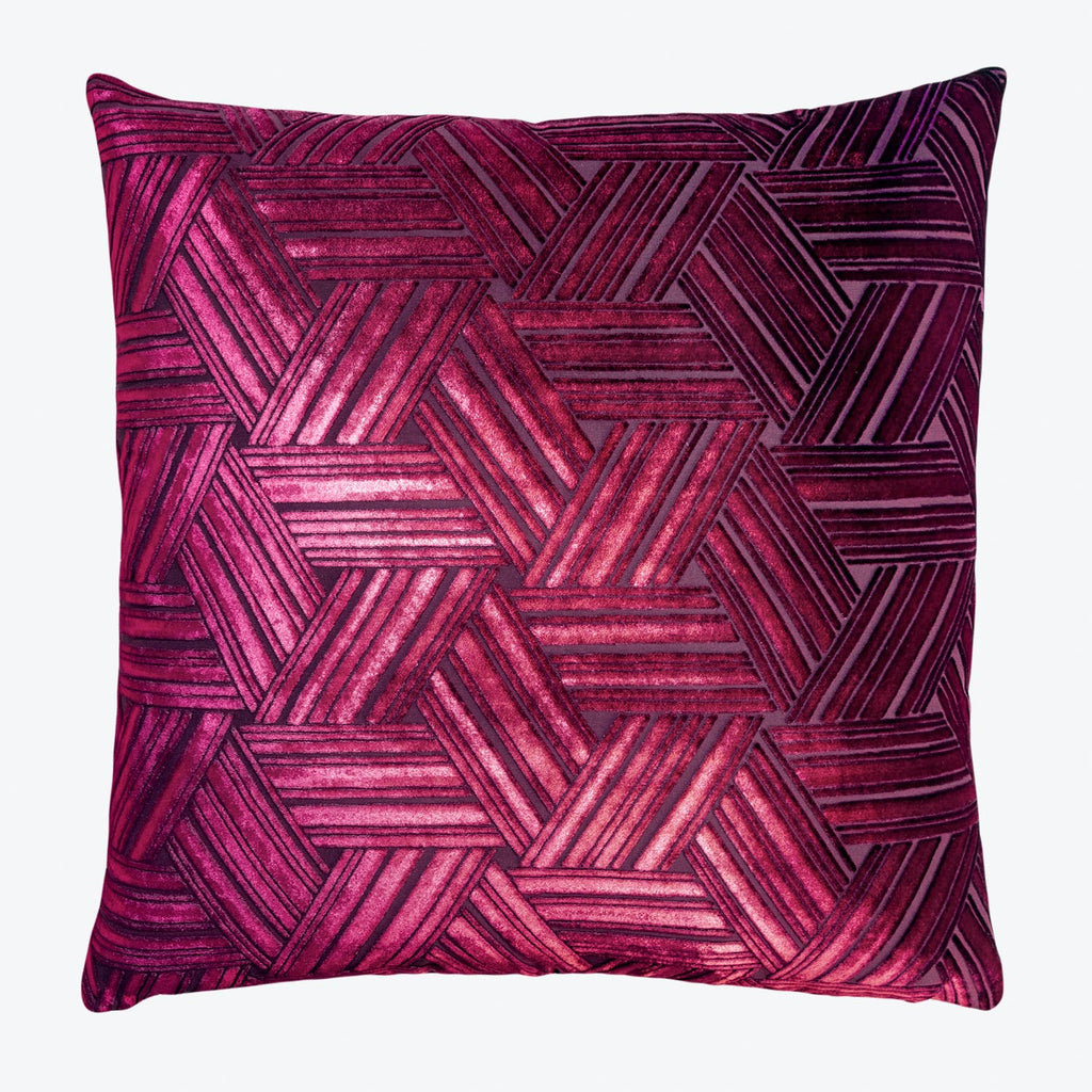 Decorative pillow with a geometric herringbone pattern in deep pink and burgundy.