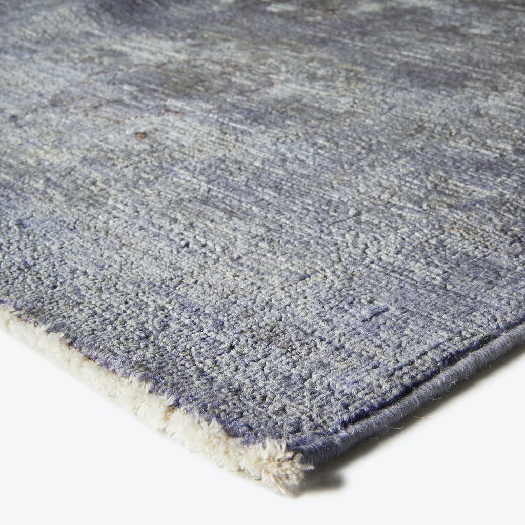 Close-up of a plush blue rug with gradient effect.