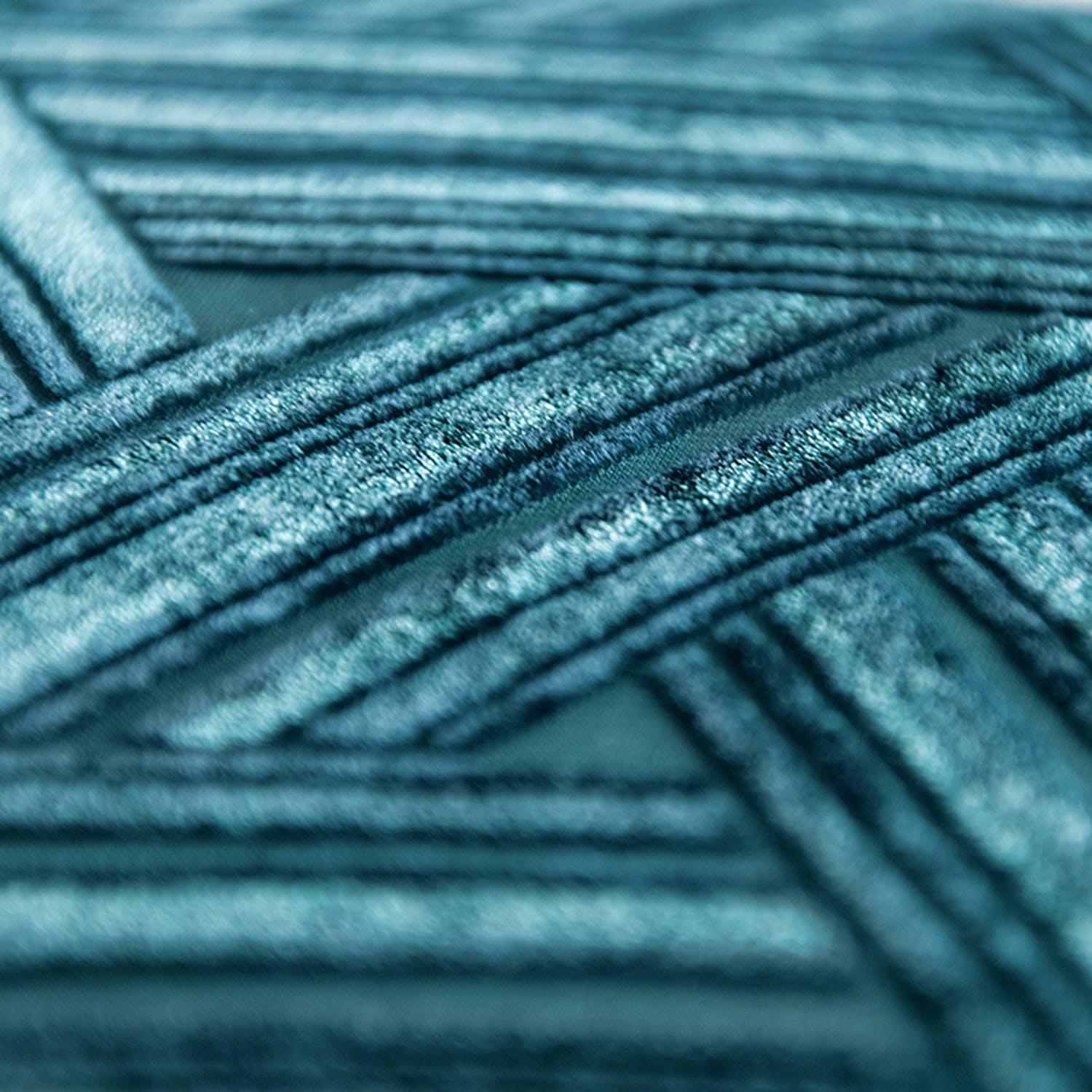 Close-up of teal textured material displays intricate linear patterns.