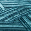 Close-up of teal textured material displays intricate linear patterns.