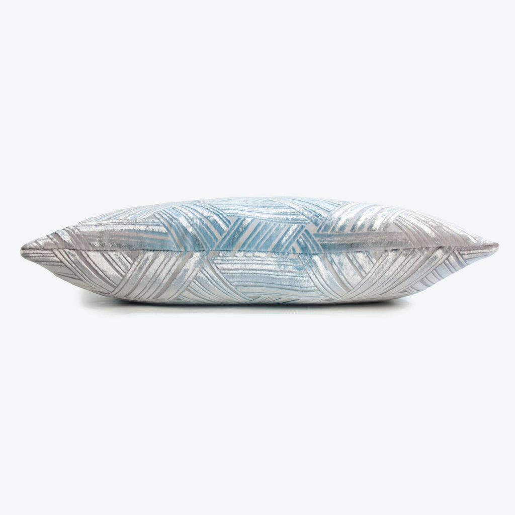 Plush geometric pillow with icy hues on a sleek background.