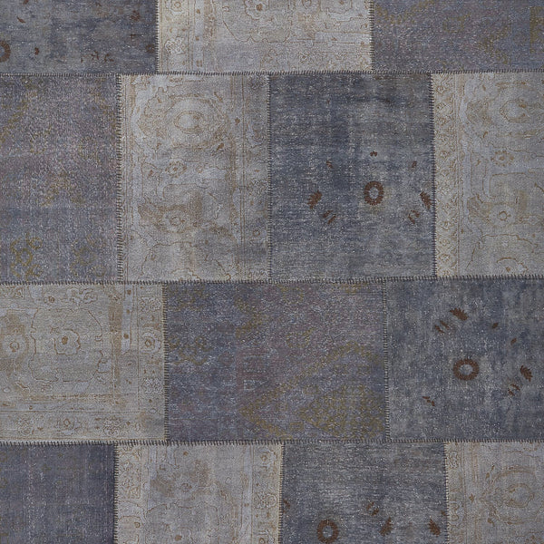 Vintage-inspired patchwork textile showcasing faded blue and gray patterns.