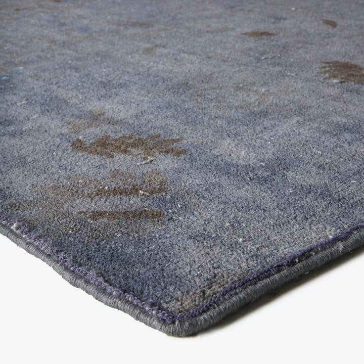 Close-up of plush, deep blue carpet with abstract design patterns.