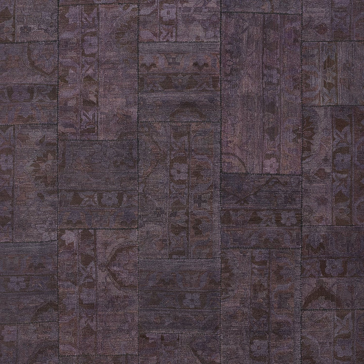 An intricate purple textile showcasing a patchwork of ethnic motifs.