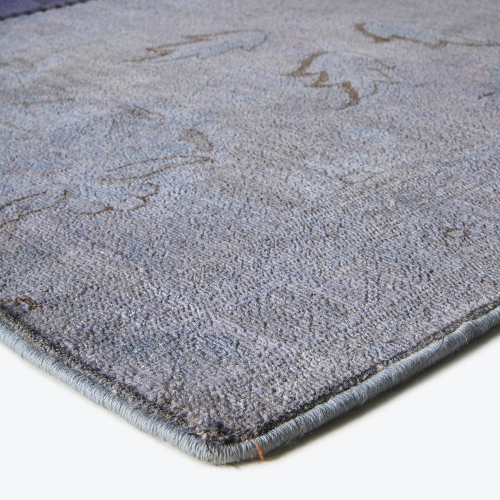 Close-up of a plush gray carpet with visible yarn tufts.