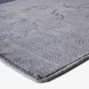 Close-up of a plush gray carpet with visible yarn tufts.