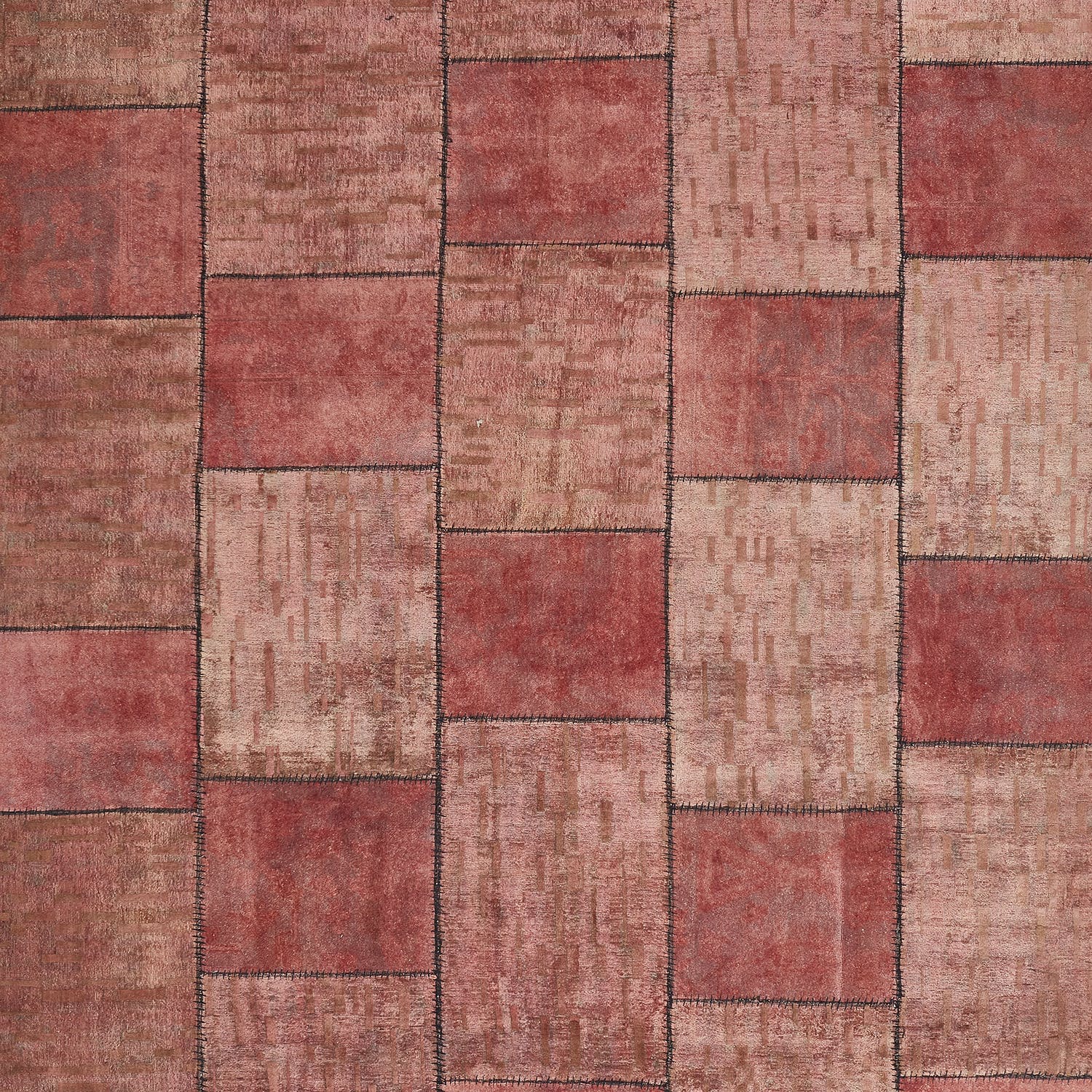 Patchwork textile-like surface with red and beige square blocks