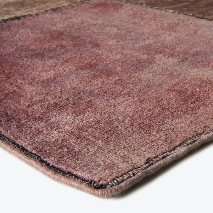 Close-up of a plush, ombré rug with bound edges.