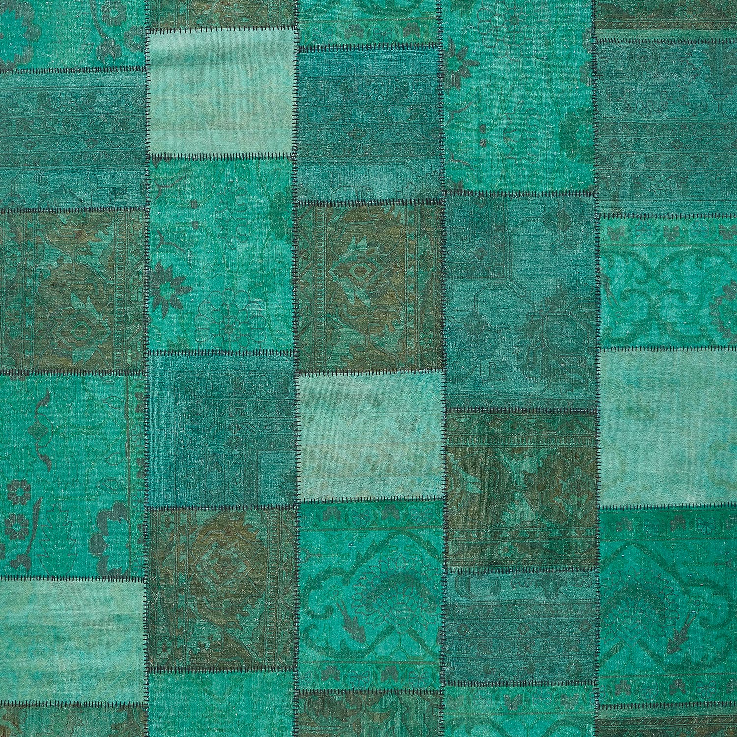 Vintage teal fabric patchwork showcases intricate designs and distressed textures.