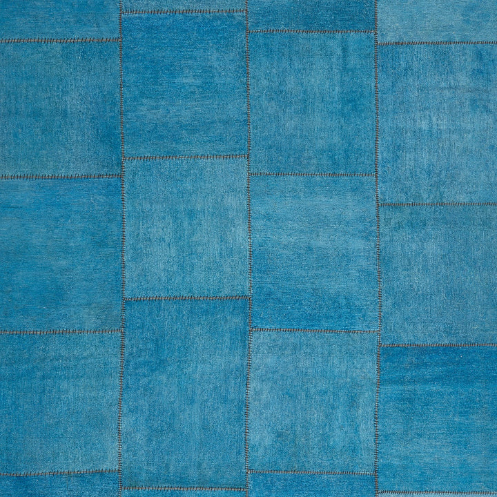 Patchwork of blue denim textures showcasing fading and distress variations.