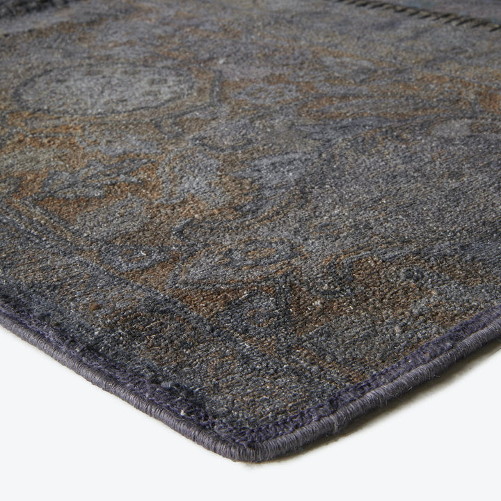 Close-up of a plush, intricate carpet with muted tones.