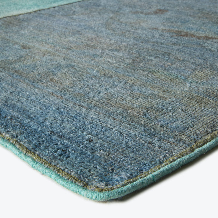 Close-up view of a soft, thick textured rug with gradient colors.