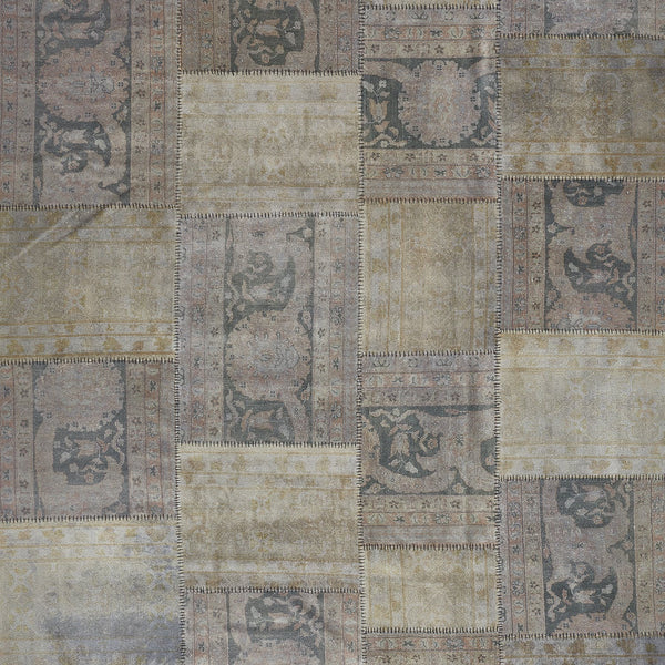Vintage patchwork quilt with ornamental designs and muted color palette.