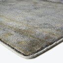 Close-up of a luxurious, textured rug with a stone-like pattern.