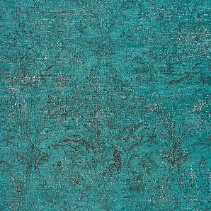Teal/turquoise fabric with textured, floral pattern, perfect for interior design or fashion.