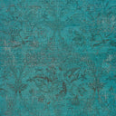 Teal/turquoise fabric with textured, floral pattern, perfect for interior design or fashion.