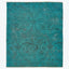 Intricate floral pattern in teal fabric with textured woven design.