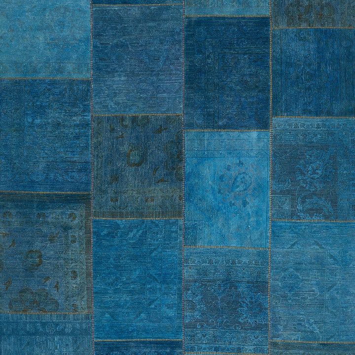 Vibrant blue patchwork design with intricate patterns and quilt-like stitching