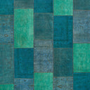 An abstract patchwork of blue and green squares and rectangles.