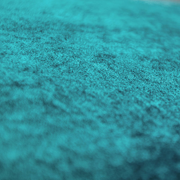 Close-up of rich teal fabric with soft, fuzzy texture detail.