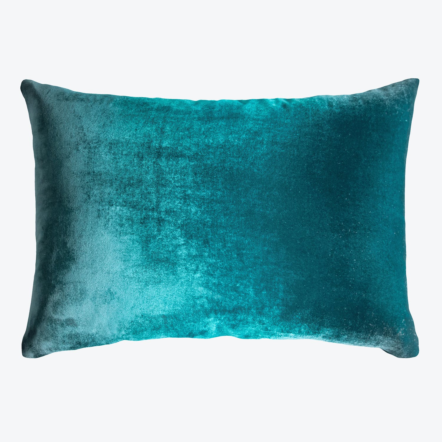 Vibrant teal plush pillow with gradient texture adds decorative touch.