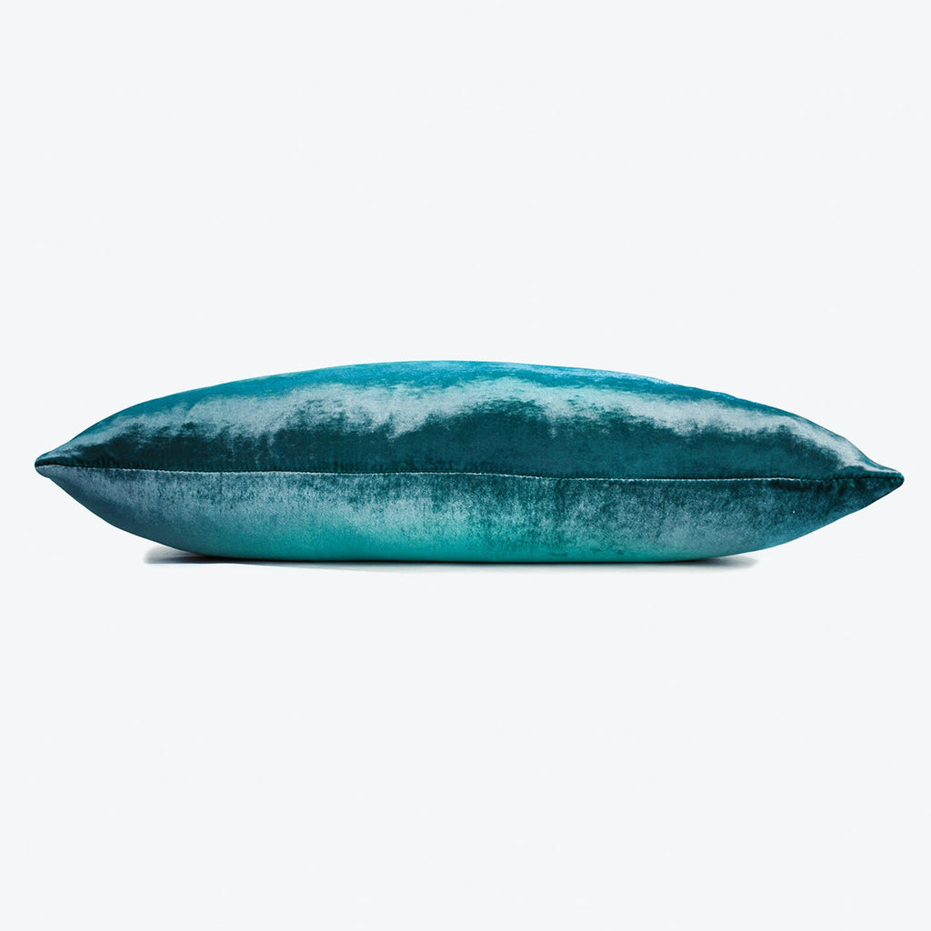A luxurious velvet pillow with a stunning blue ombre gradient.