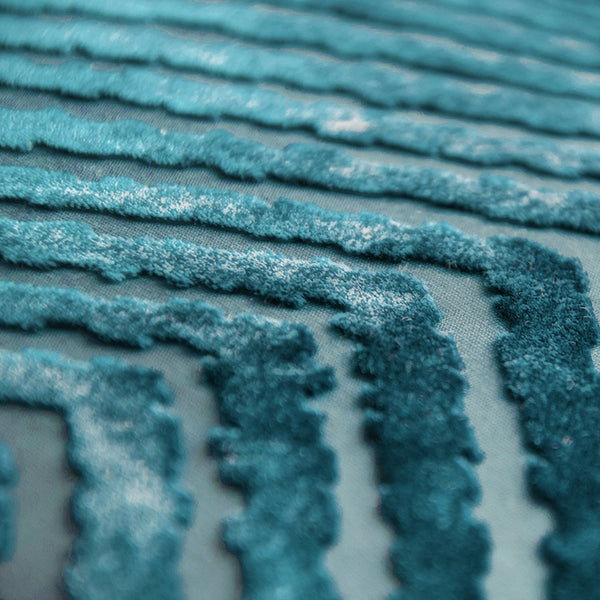 Close-up of teal textured fabric with plush, wave-like lines
