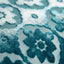 Close-up of floral patterned fabric with raised velvet-like texture.