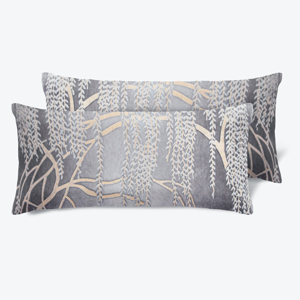 Matching leaf-patterned pillows add a nature-inspired touch to any interior.