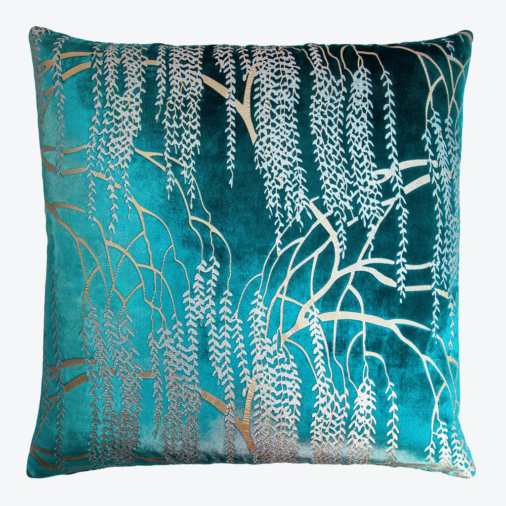 Vibrant teal throw pillow with botanical-inspired silver and gold design.