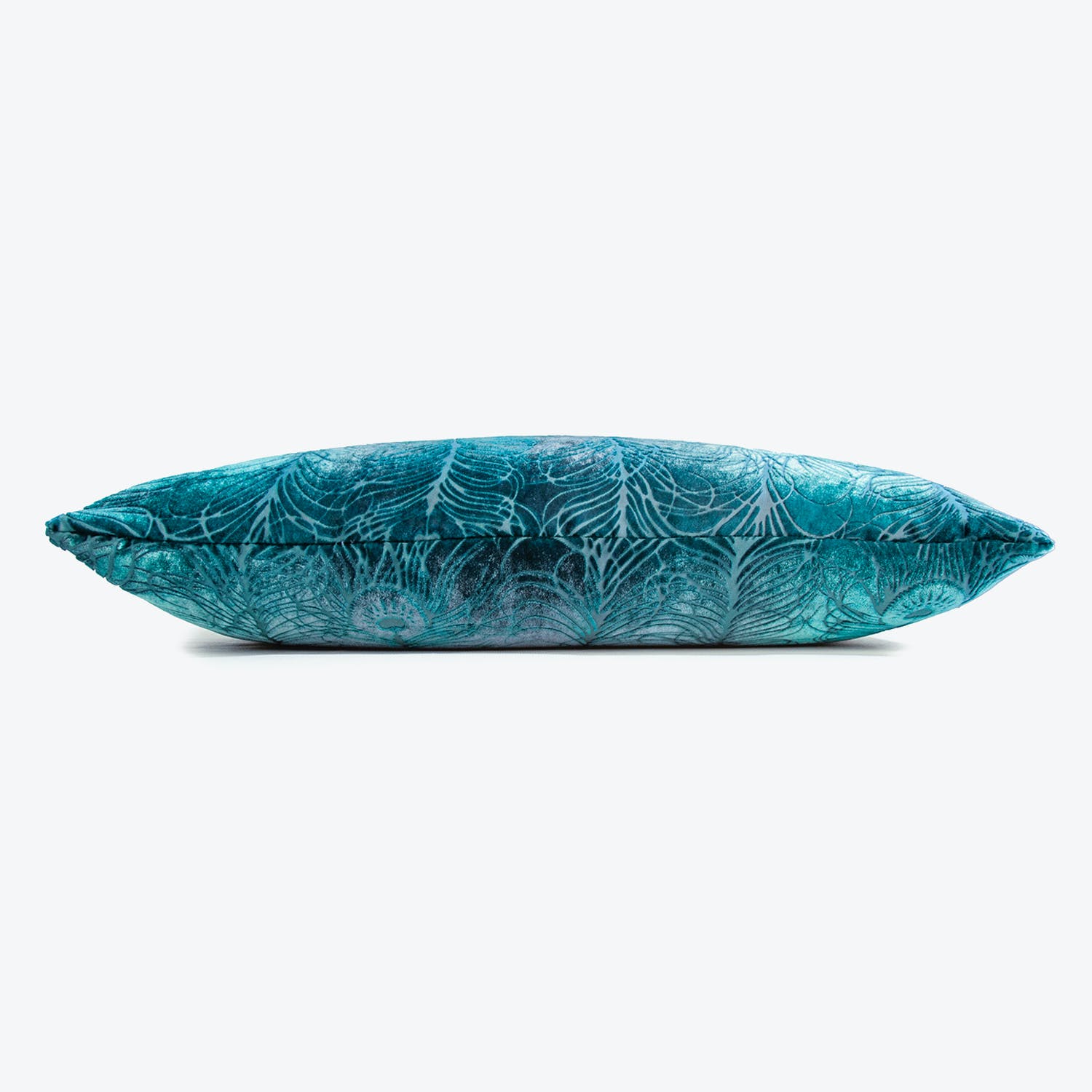 Vibrant teal leaf patterned pillow with plush, elongated shape.