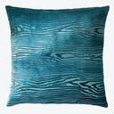 Vibrant blue pillow with textured pattern resembling flowing water waves.