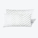 Soft and stylish white pillows with modern chevron pattern design.