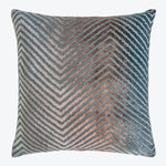 Decorative chevron-patterned pillow in blues, grays, and browns on white background.
