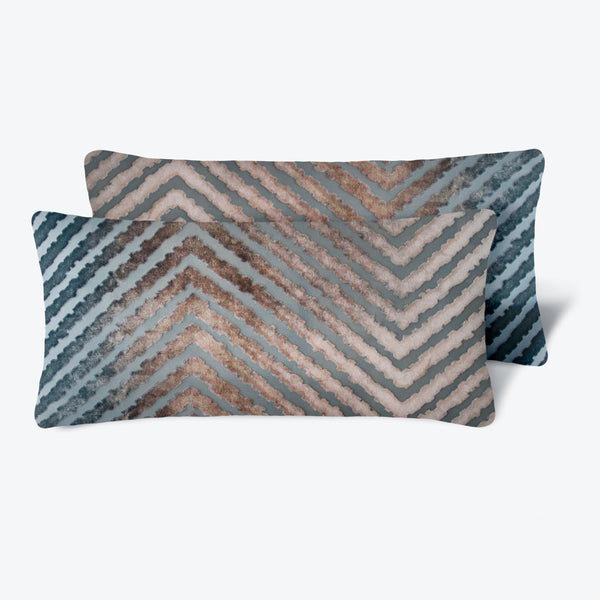 Modern chevron patterned pillows in blue, teal, gray, and brown.