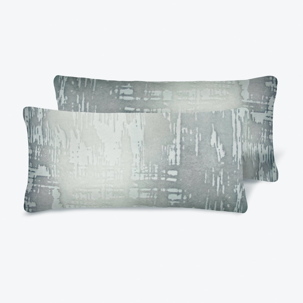 Two modern gray decorative pillows with abstract brushstroke design.