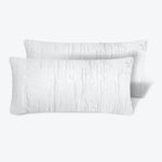 Minimalistic rectangular pillows with textured brush stroke pattern in white.