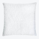 White decorative pillow with three-dimensional quilted pattern for home decor.