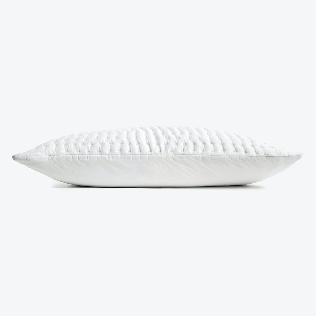 Single white pillow with quilted texture, perfect for comfortable rest.