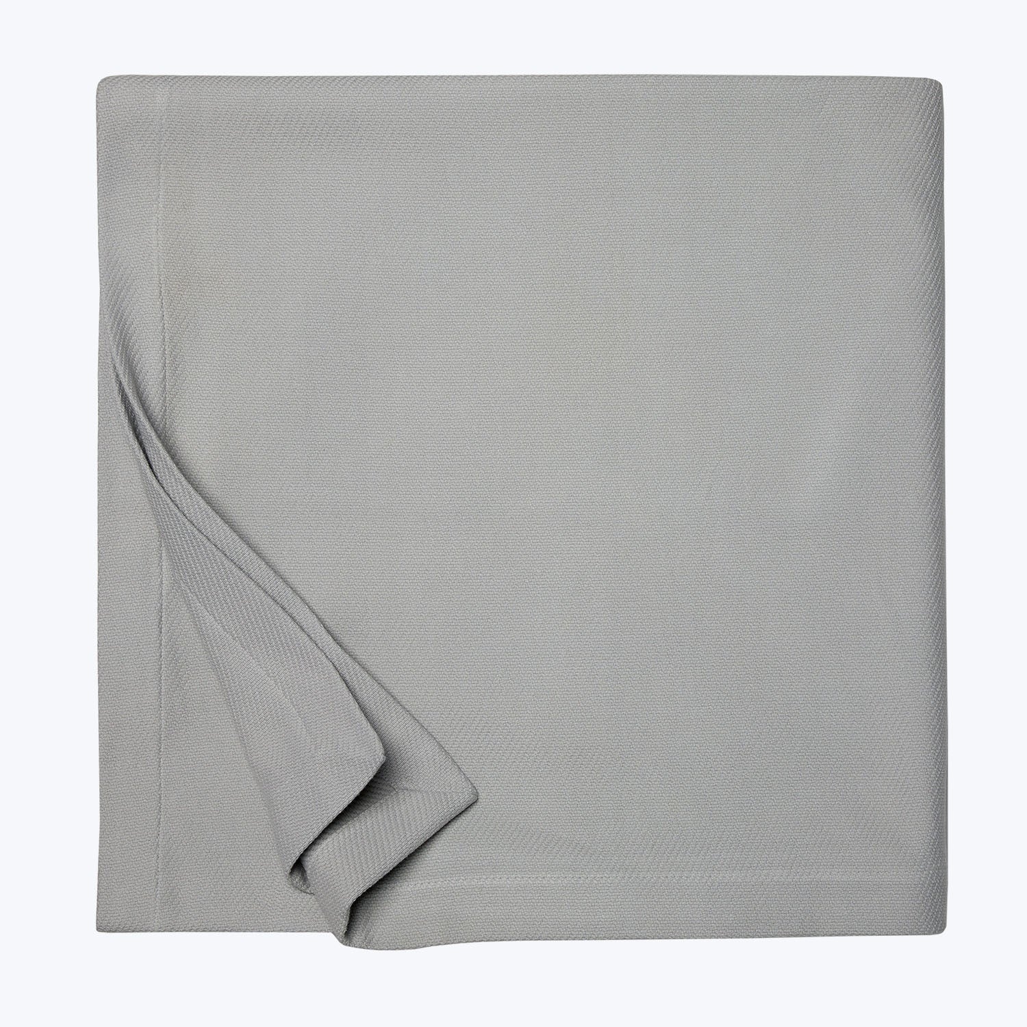 Neatly folded gray fabric with a smooth, tight weave showcased.