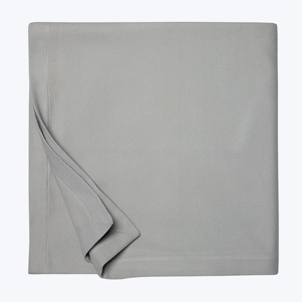 Neatly folded gray fabric with a smooth, tight weave showcased.