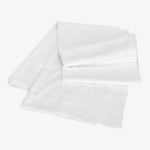 Neatly folded white pillowcases with elegant stitched borders on display.