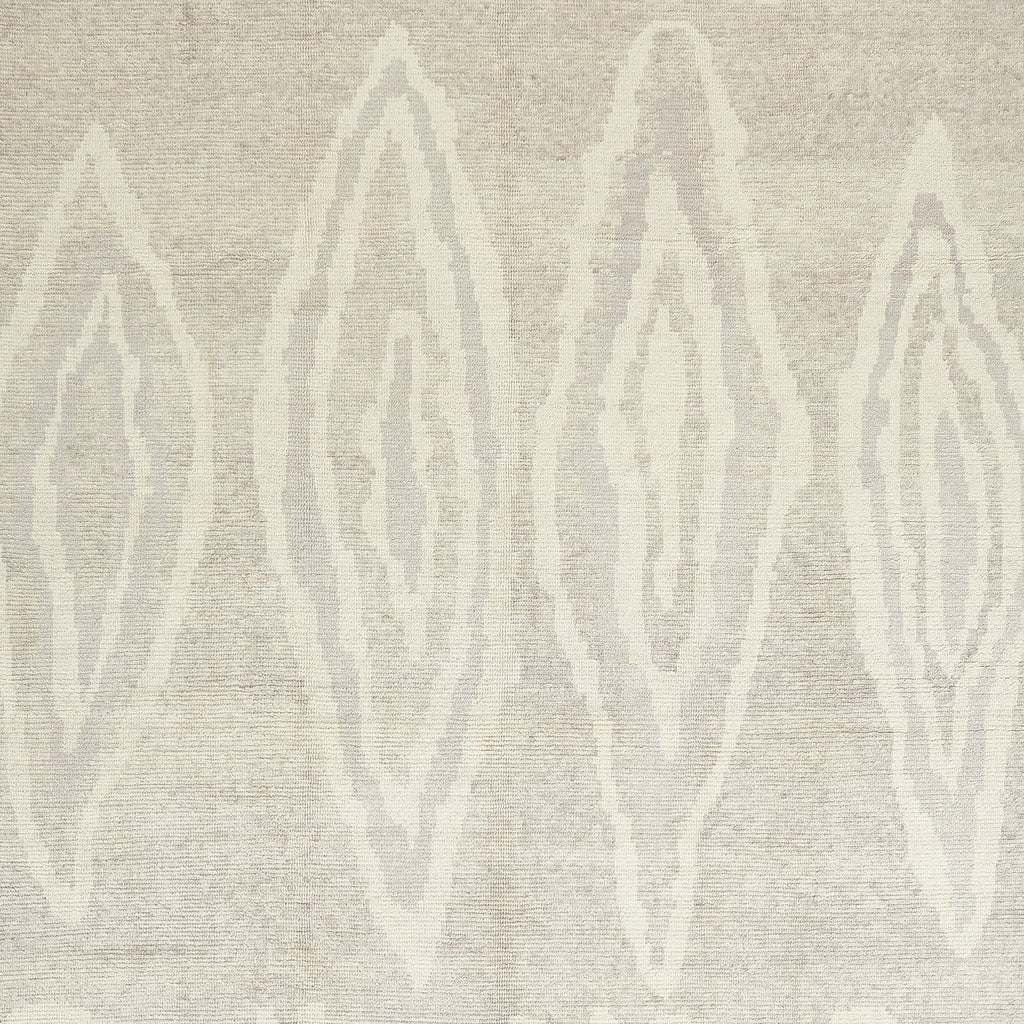Textured beige background featuring symmetrical leaf-like shapes in whitish-beige.